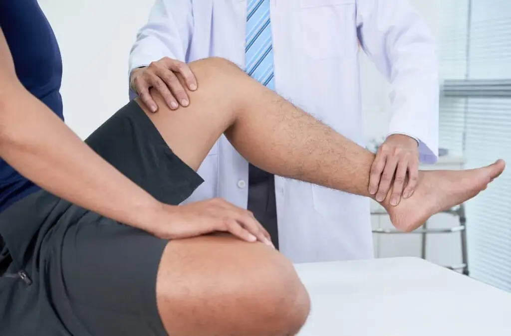 Doctor checking leg