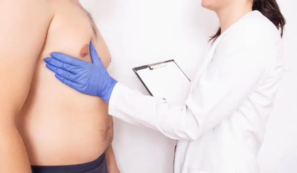 doctor checking breasts
