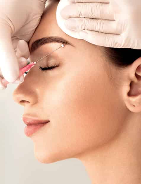 woman getting eyebrow treatment